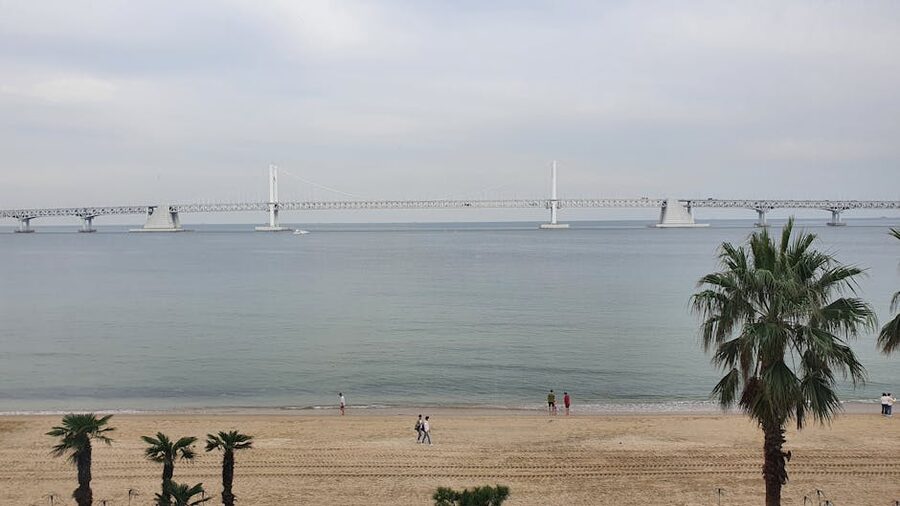 Gwangalli Beach with Gwangan Bridge and sunset clouds in Busan