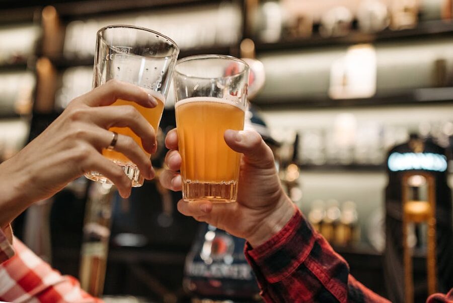 Friends toasting with beer glasses on a Busan pub crawl