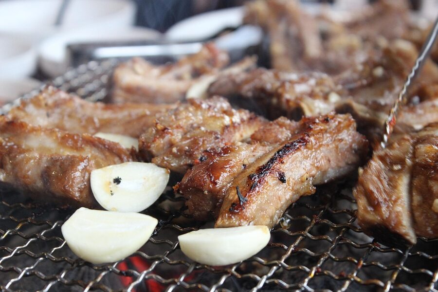 Korean BBQ garlic ribs cooking over fire