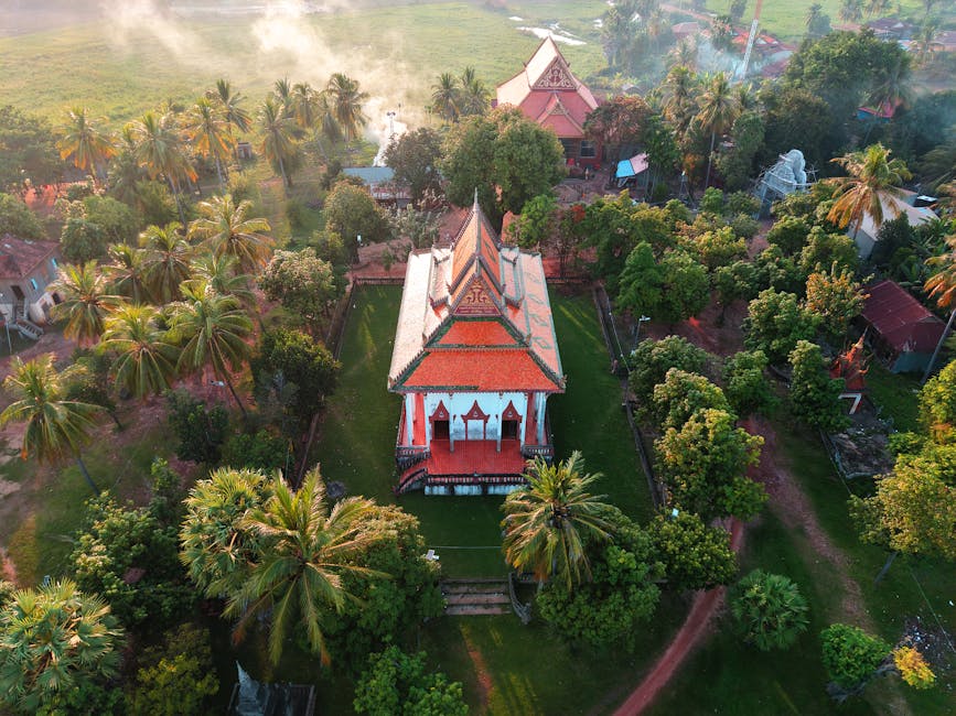 Cambodian temple amidst lush greenery aerial shot