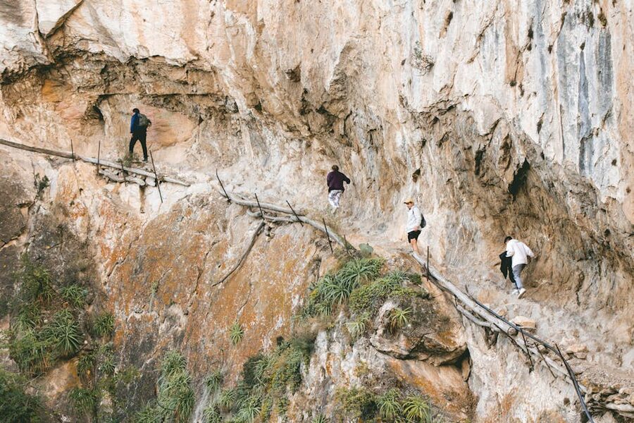 Hikers on the narrow rocky path of Caminito del Rey