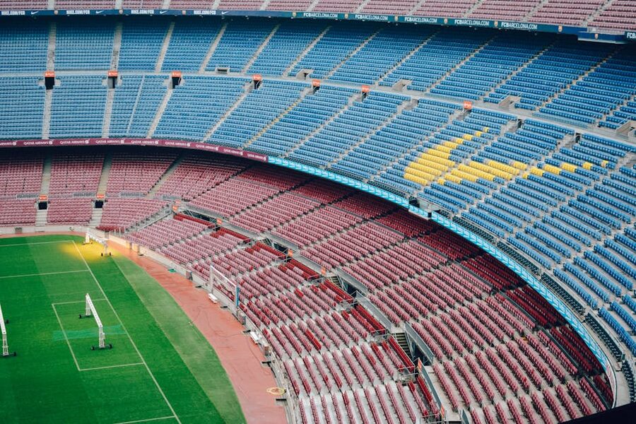 Aerial view of empty Camp Nou stadium with blue and red seats