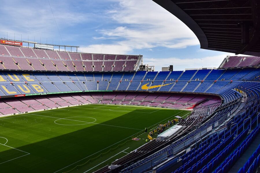 Wide view of Camp Nou empty stands and lush green pitch