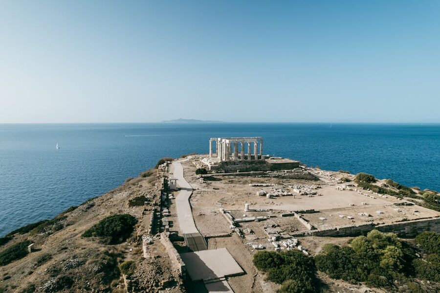 Aerial of ancient ruins on cliff above the sea at Cape Sounion