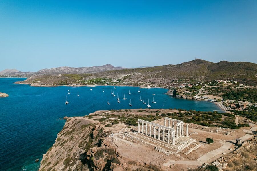 Aerial of Cape Sounion with sailboats on the Aegean Sea