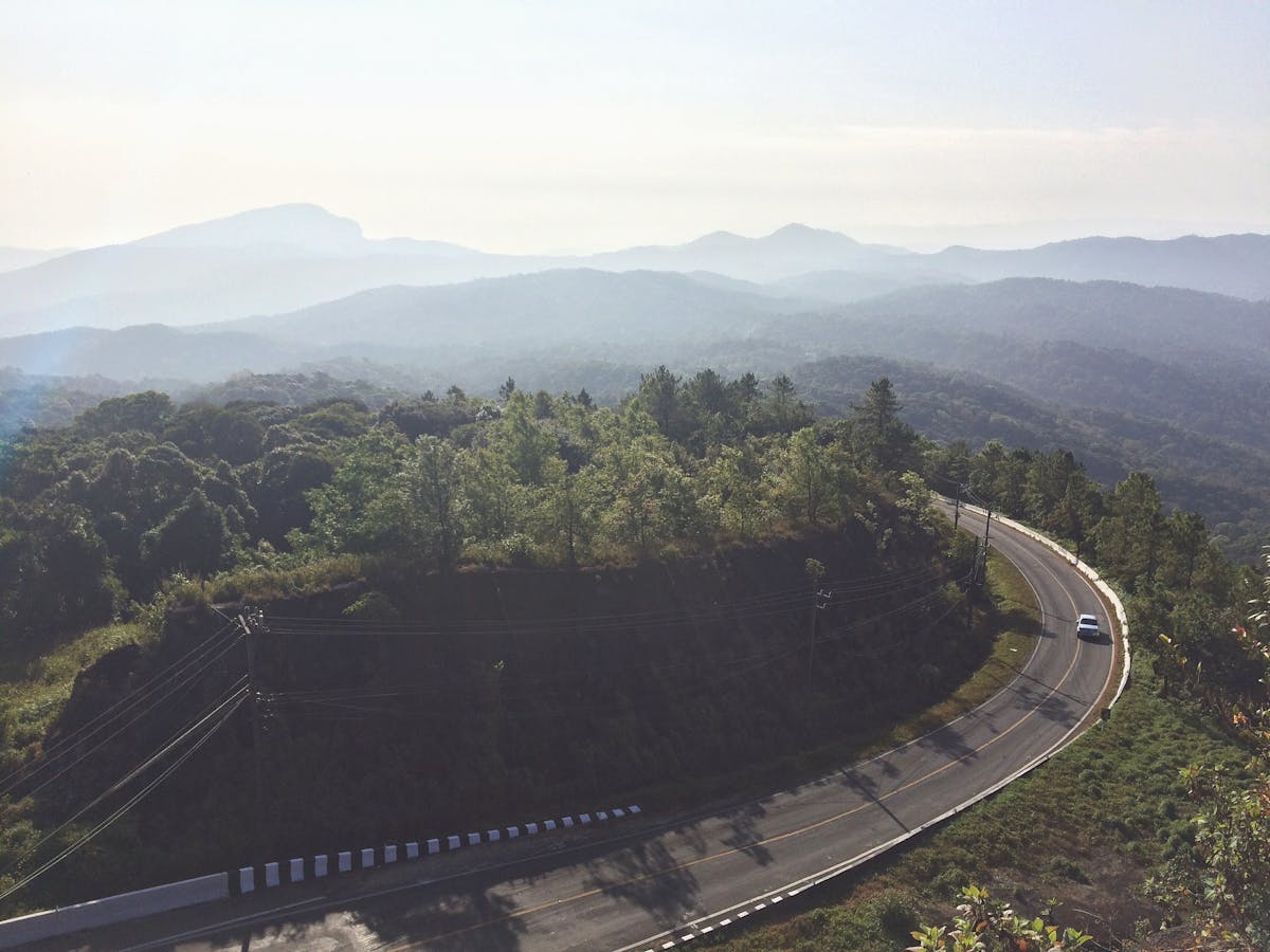Aerial view of winding road through lush green mountains near Chiang Mai Thailand