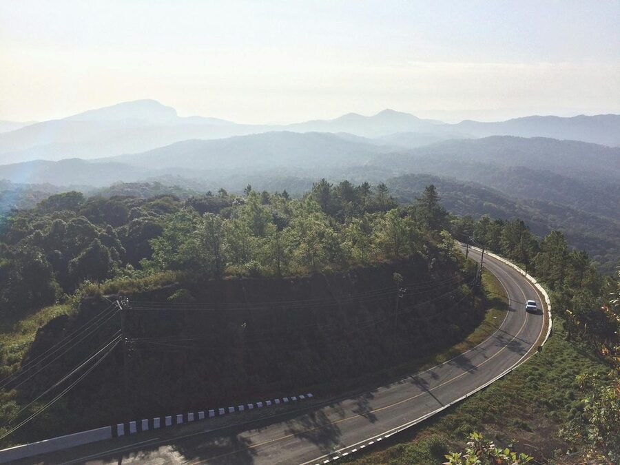 Aerial view of winding road through mountain forest in Chiang Mai Thailand