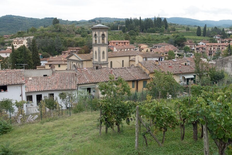 Greve in Chianti hilltop village with bell tower and surrounding vineyards