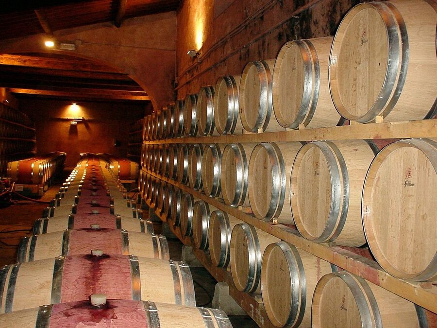 Wooden wine barrels in a Tuscan winery cellar