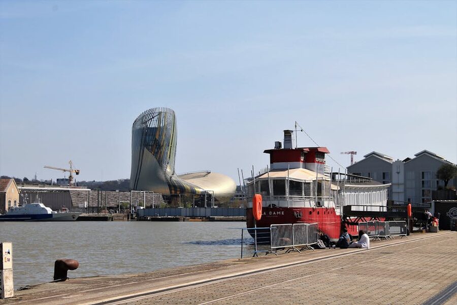 La Cite du Vin from the Garonne river with a ferry passing