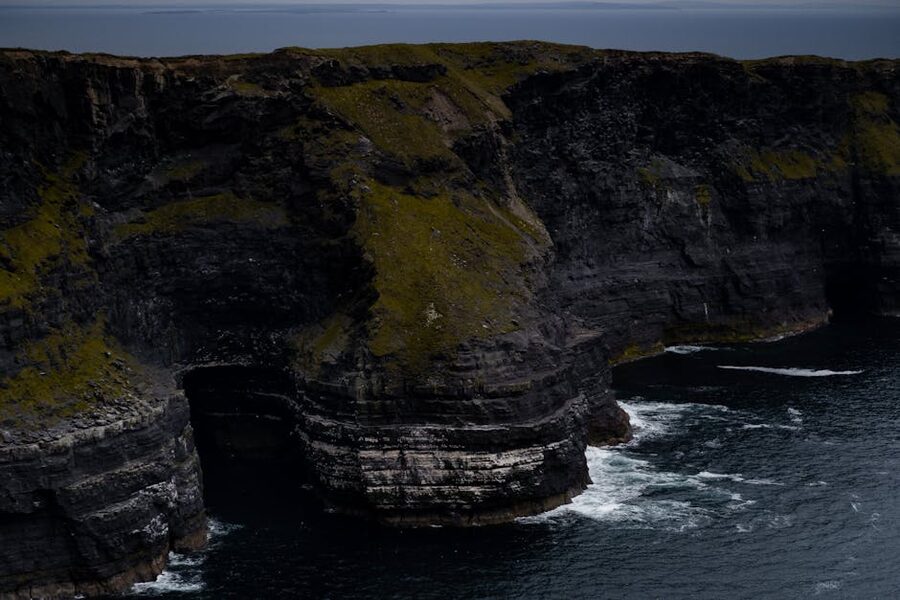 Cliffs of Moher in fog with waves crashing below
