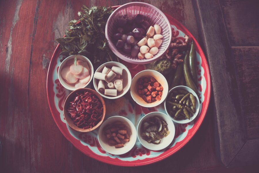 Colorful assortment of Thai cooking ingredients on a rustic wooden table