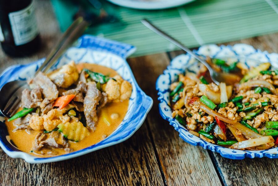 Display of authentic Thai dishes with vegetables in traditional bowls