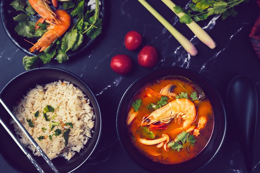 Thai Tom Yum soup with shrimp served alongside white rice