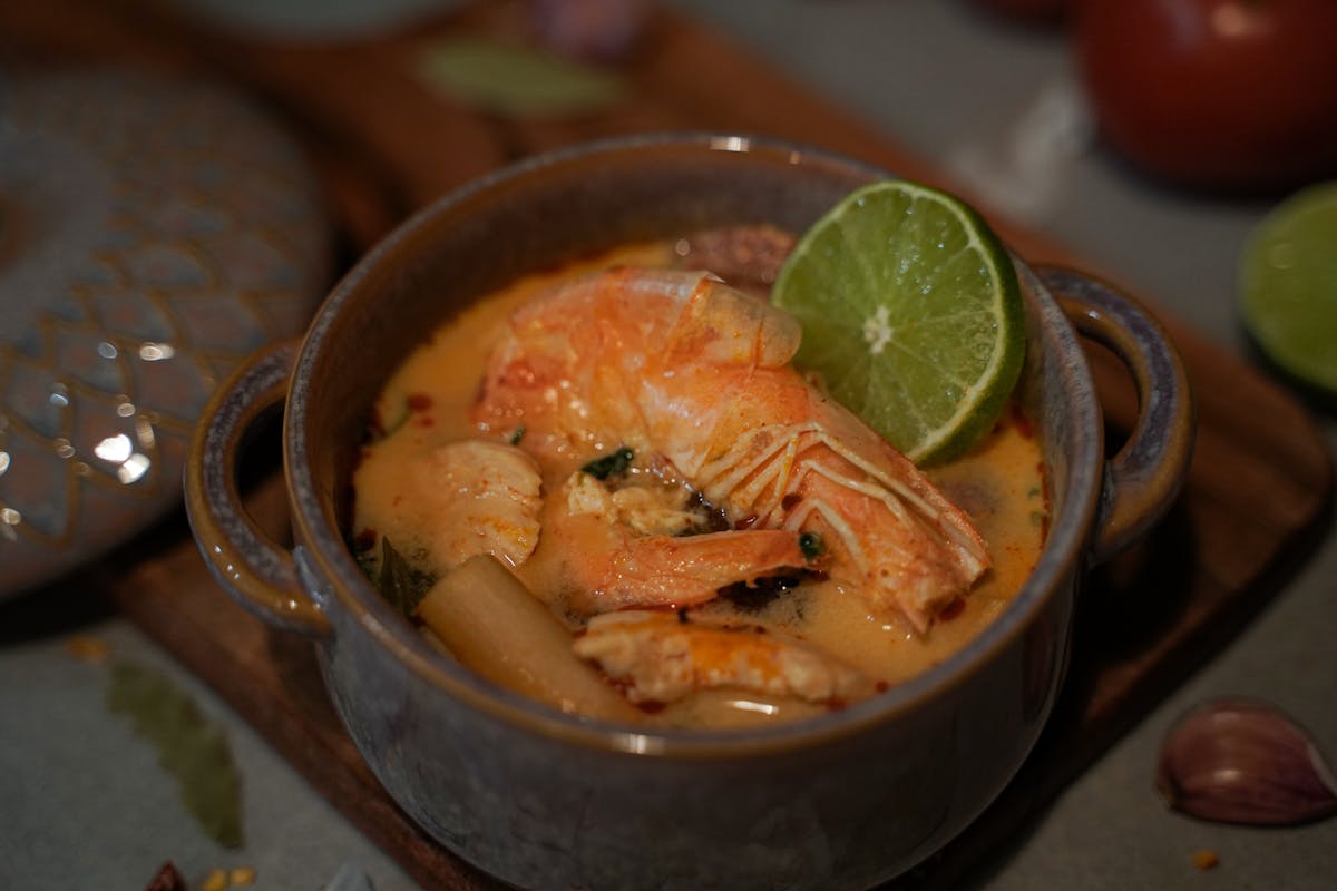 Homemade Thai Tom Yum soup with fresh shrimp and lime