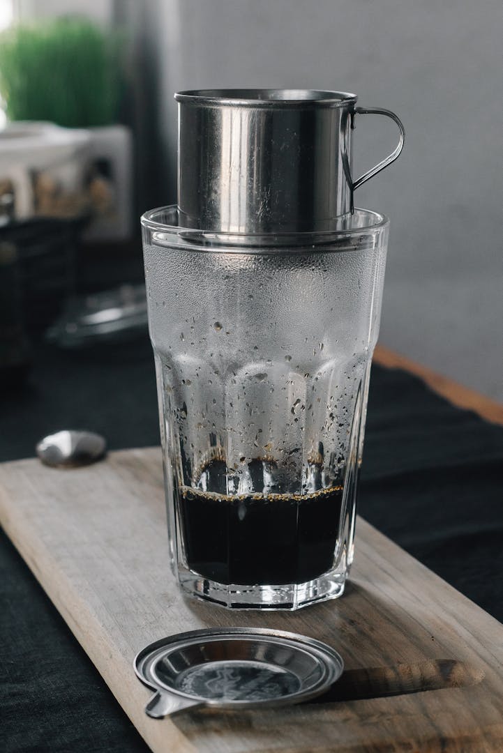 Traditional Vietnamese coffee beans being ground on a simple hand grinder