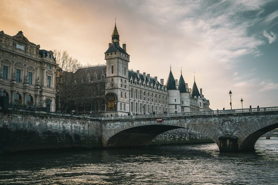 Conciergerie and Pont au Change at sunset over the Seine in Paris