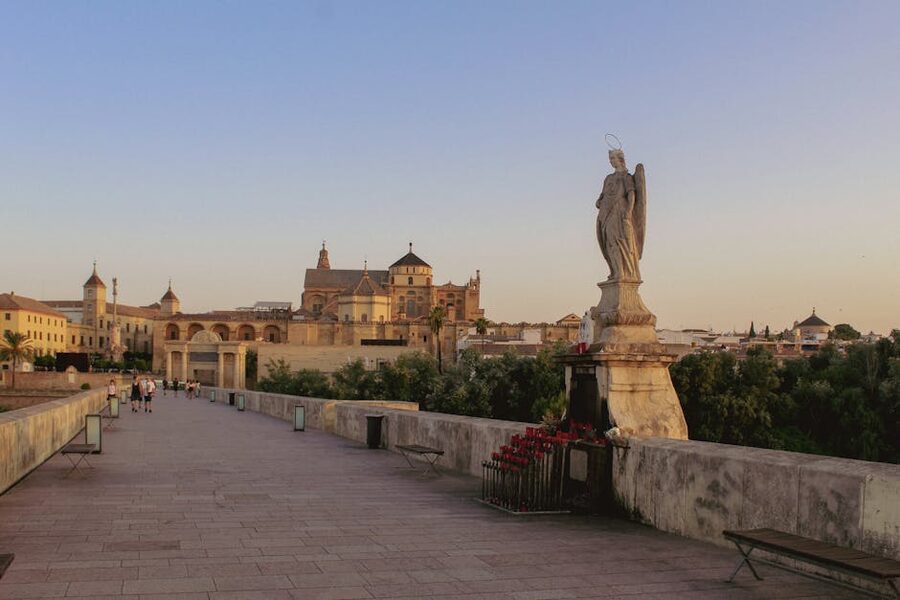 Cordoba Roman Bridge at sunset with the Mezquita silhouette