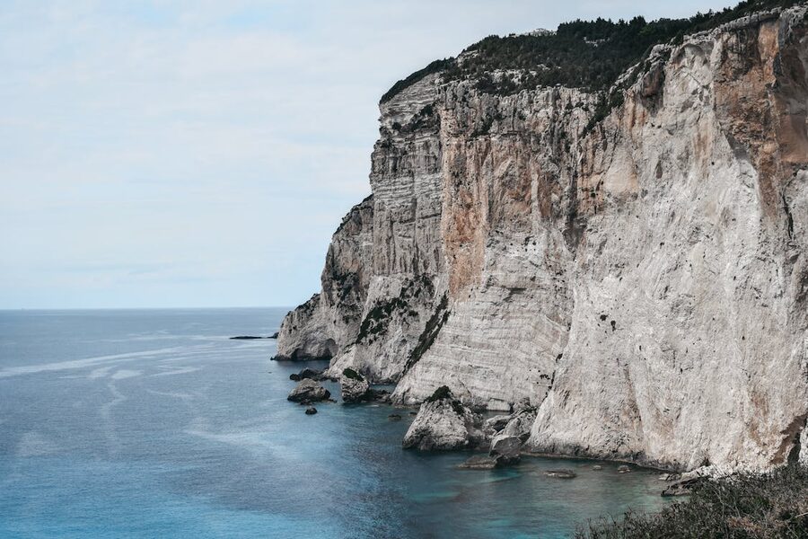 Paxos cliffs coast under blue sky Greek island