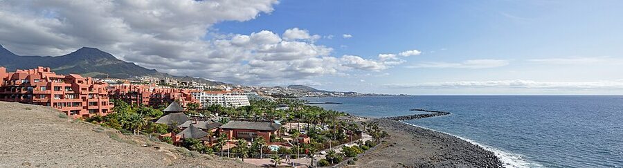 Costa Adeje seafront promenade with palm trees and Atlantic Ocean view