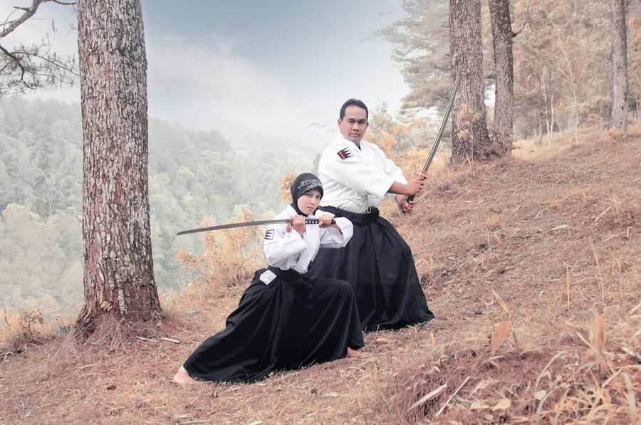 Couple demonstrating martial arts with katanas