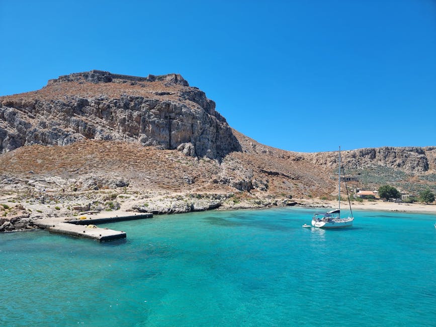 Gramvousa sailboat turquoise water Crete coastline aerial