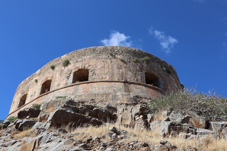 Spinalonga ancient stone fortress walls Crete blue sky