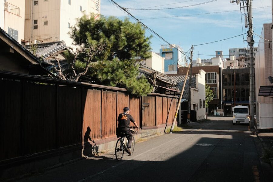 Cyclist on a Japanese street with old wooden houses