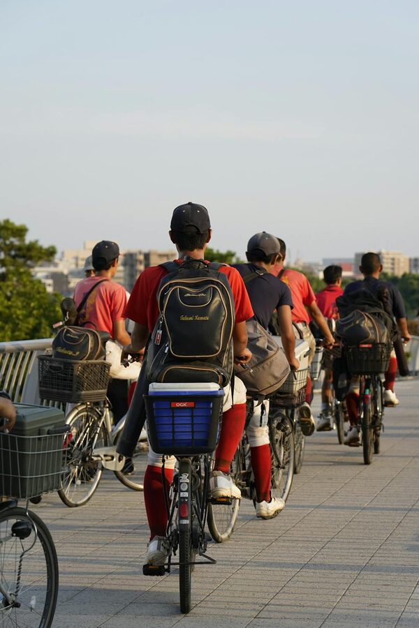 Group of cyclists riding through Tokyo streets during golden hour sunset