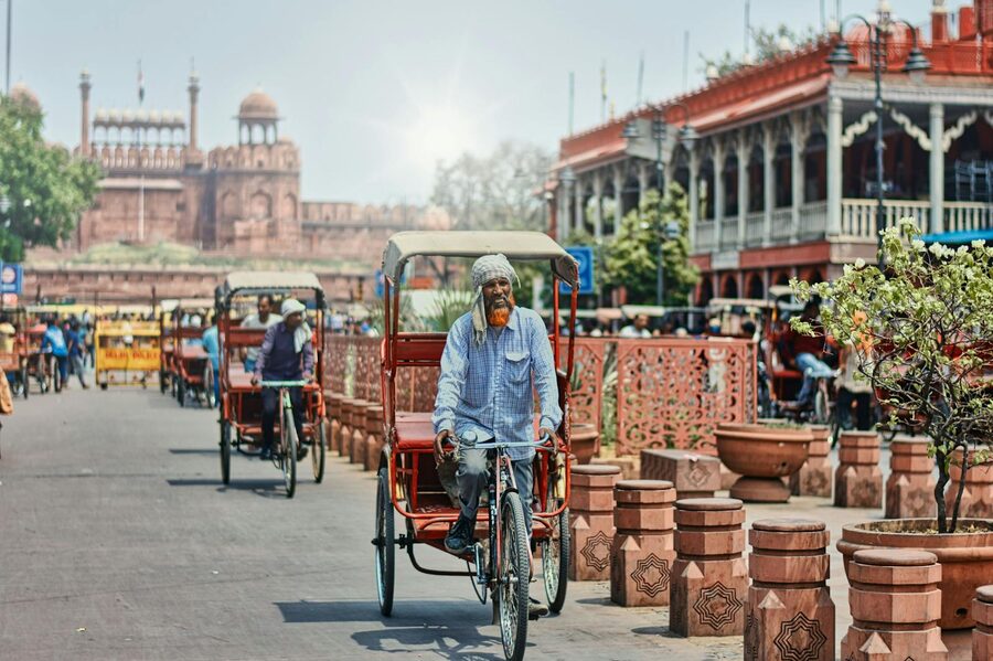 Cycle rickshaws and pedestrians in the busy streets of Old Delhi