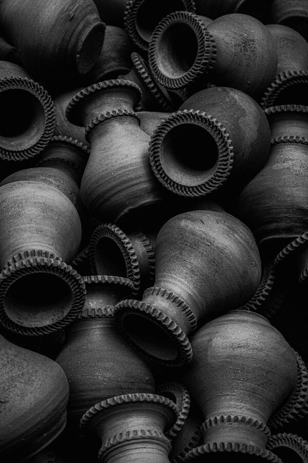 Stacked hand-thrown clay pots in a Mumbai pottery workshop