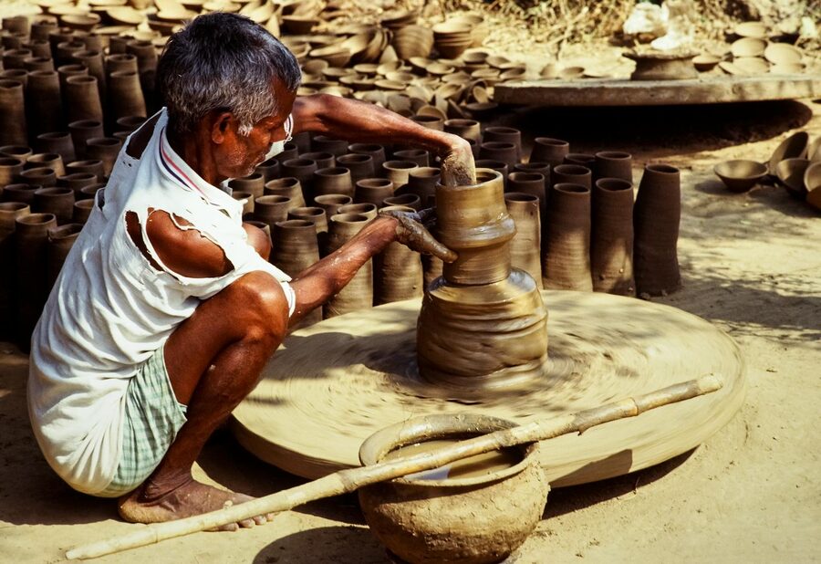 Traditional potter shaping clay on a wheel