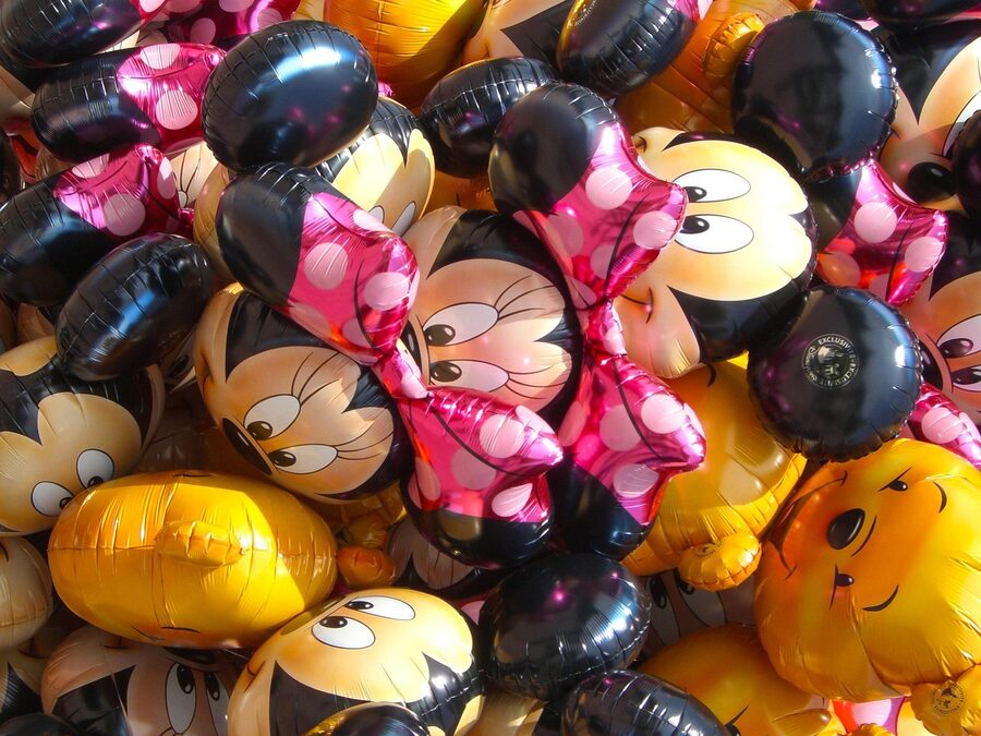 Mickey balloons floating at Disneyland Paris with the castle in the background