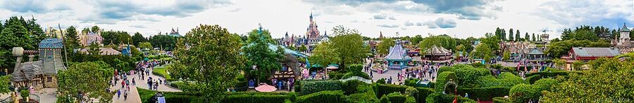 Wide panorama of Fantasyland at Disneyland Paris with the castle and rides