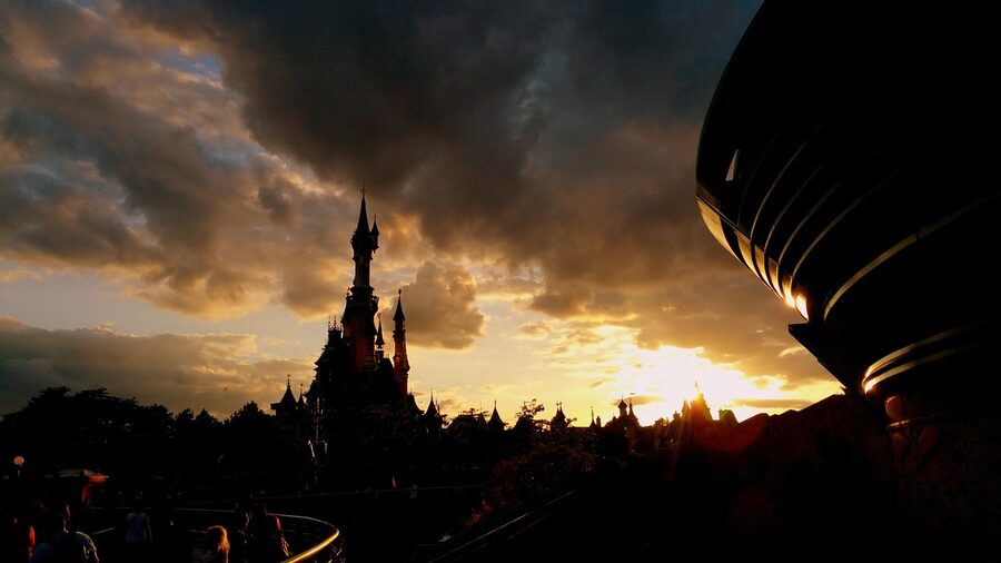 Sunset over Disneyland Paris with the sky glowing orange