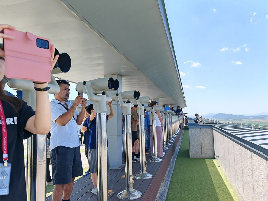 Visitors looking through binoculars at Dora Observatory DMZ