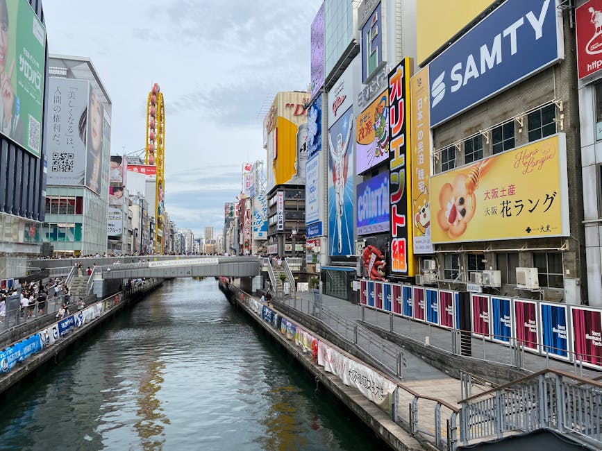 Dotonbori Canal with colorful signs and pedestrians in Osaka
