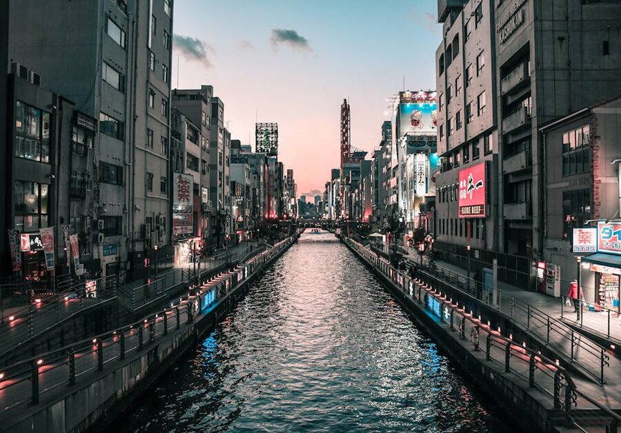 Dotonbori Canal at twilight in Osaka Japan with city lights reflecting on water