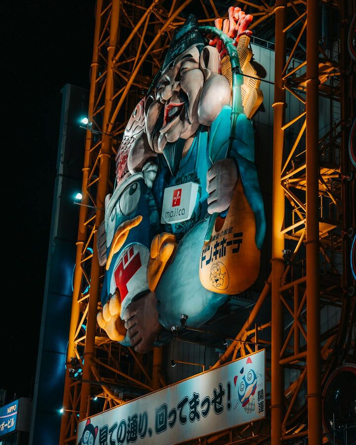 Large illuminated sign over Dotonbori canal at night in Osaka