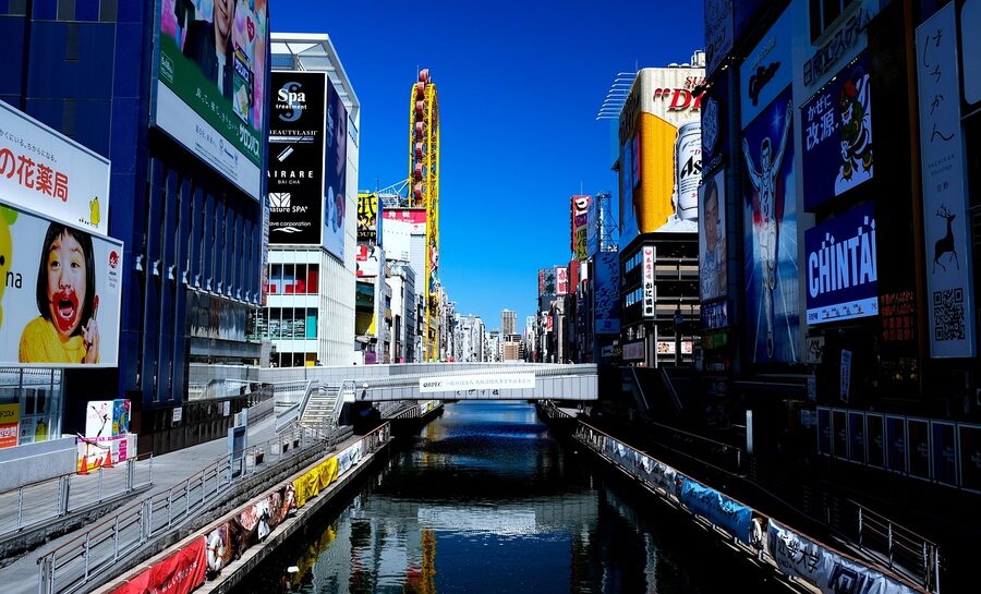 Dotonbori Glico Running Man sign at night with neon reflections Osaka