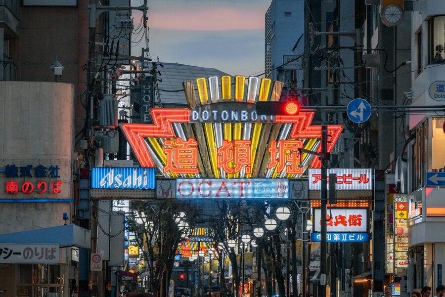 Neon-lit street scene with iconic signs in Dotonbori Osaka at night