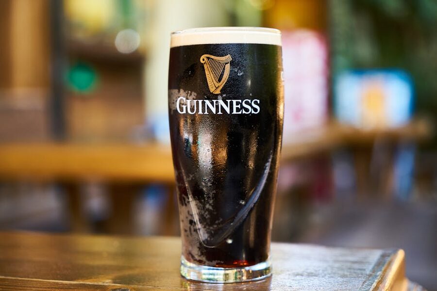 Pint of Guinness on a wooden bar table Dublin