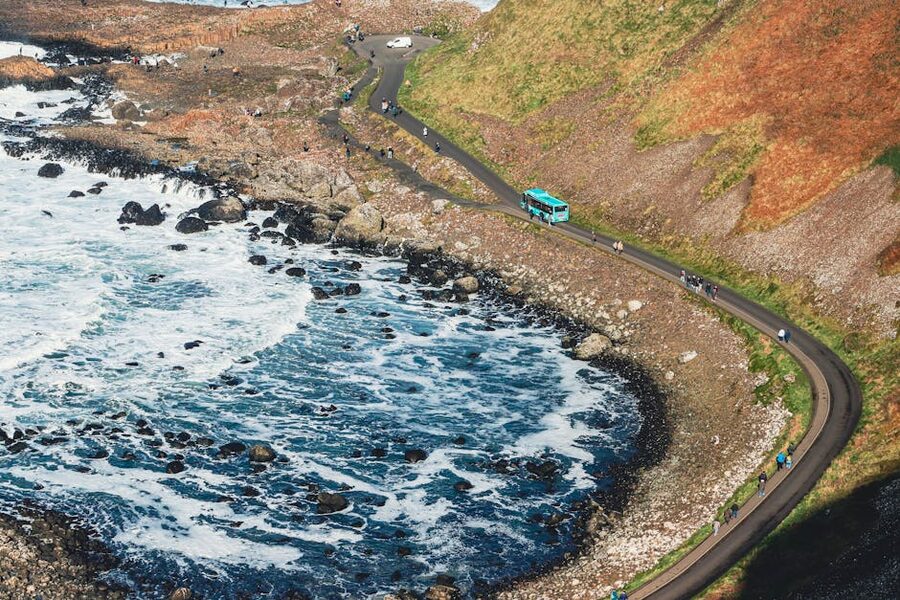 Antrim coastal road winding past green cliffs Northern Ireland