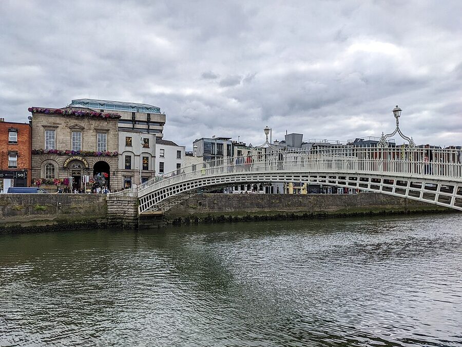 The white-painted iron Ha'penny Bridge spanning the River Liffey in Dublin