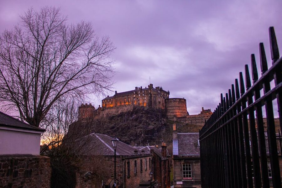 Edinburgh Castle silhouetted against purple twilight sky