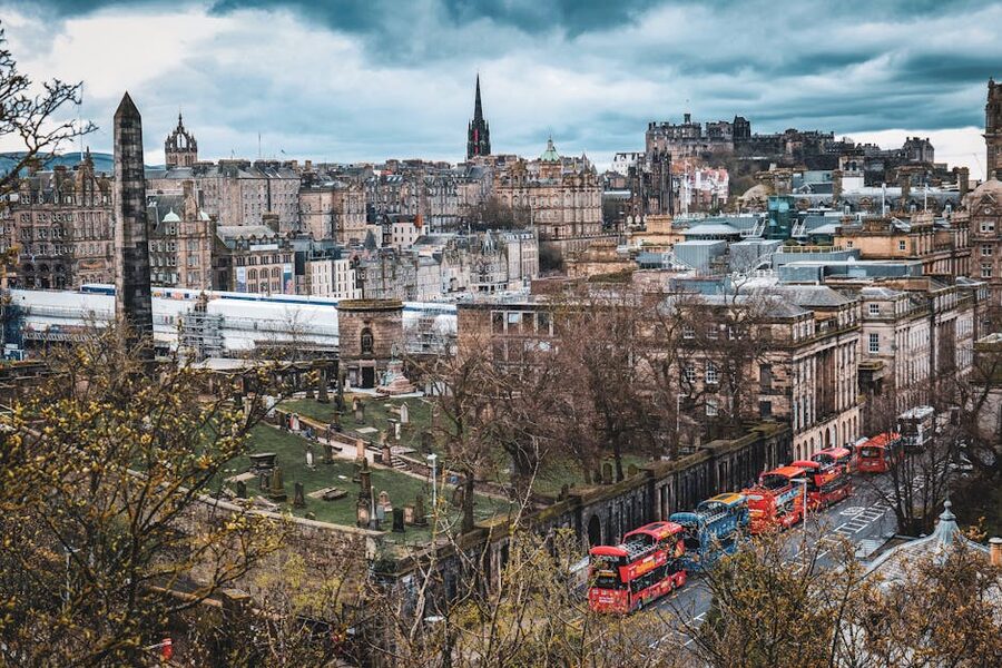 Aerial view of Edinburgh cityscape with red sightseeing buses