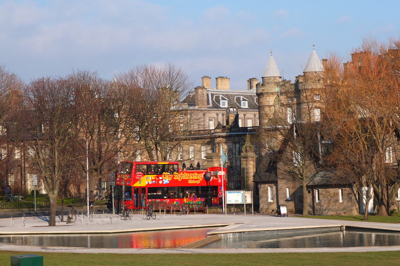Sightseeing bus passing Palace of Holyroodhouse