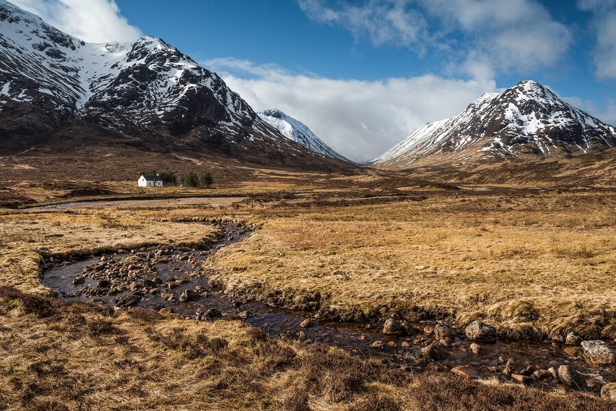 Glencoe river running through brown mountains