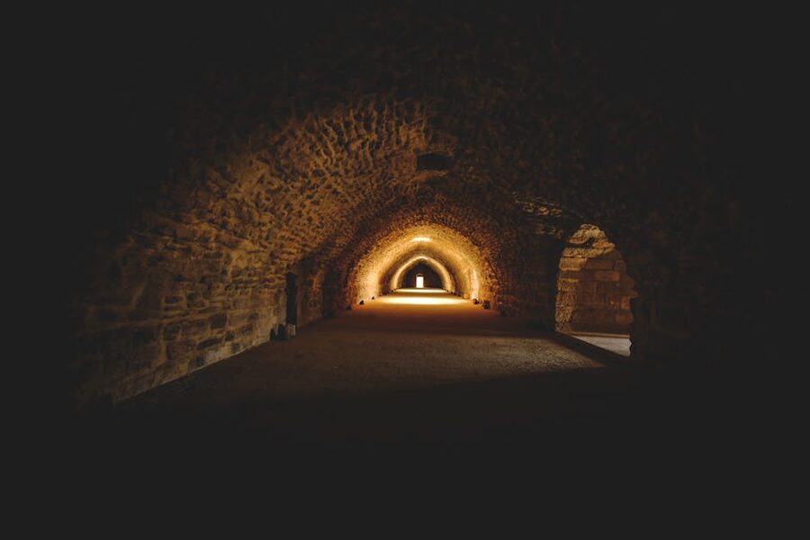 Gothic stone tunnel with warm lighting