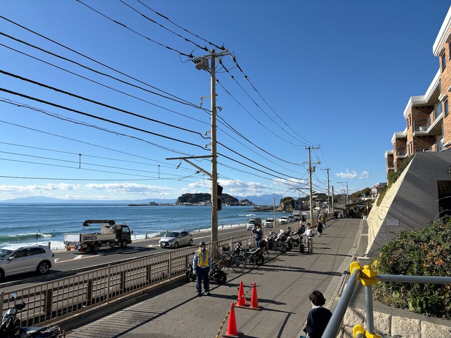 Scenic coastal road near Enoshima Island with clear blue sky and ocean view